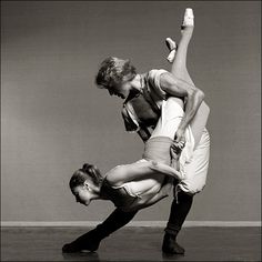 two people are doing an acrobatic dance