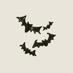 black bats flying in the air on a white background