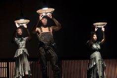 three people standing in the dark with lights on their head and one person holding two plates