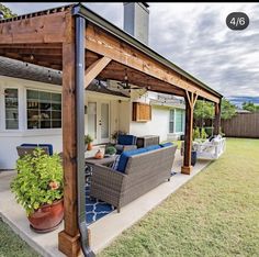 an outdoor living area with patio furniture and potted plants