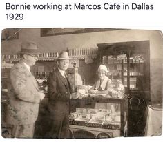 an old black and white photo of three people standing in front of a cash register