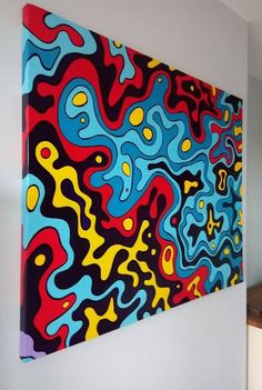 an abstract painting hangs on the wall