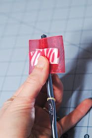 someone is holding a red piece of paper with the word love on it