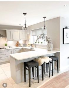 a kitchen with an island and stools in it