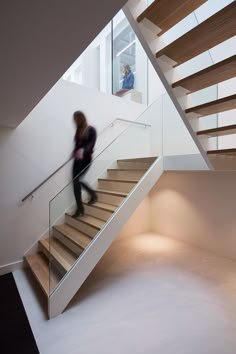 a woman walking up some stairs in a building