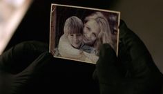 a person holding up an old photo to show it as if they were in love