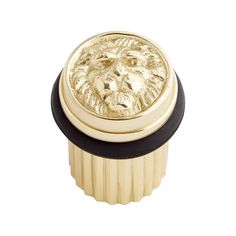 a golden lion head knob on a white background