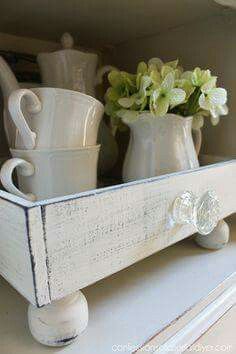 a white shelf with some cups and vases on it's bottom, and the words what a lovely project faux drawer tray from confessionals of a serial do - diy yourself