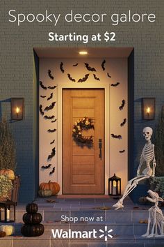 the front porch is decorated for halloween with skeletons and pumpkins