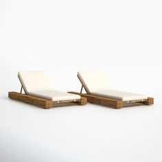 two white lounge chairs sitting next to each other on top of a white flooring