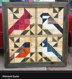 a wooden frame with an image of birds in different colors and sizes on the front