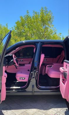 a pink car with its doors open and the door ajar is shown in this photo