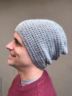 a man wearing a gray and white knitted beanie on top of his head