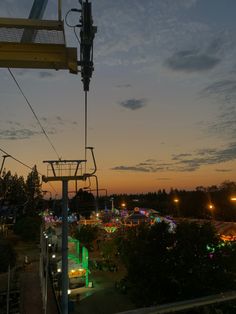 an amusement park at night with the sky in the background