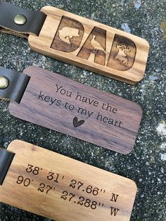 two wooden luggage tags with engraved text on them, one for dad and the other for daughter