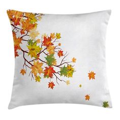 a white pillow with autumn leaves on it