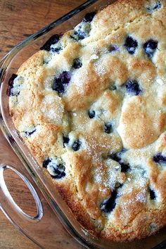 blueberry cobbler in a glass dish before and after it has been cut into pieces