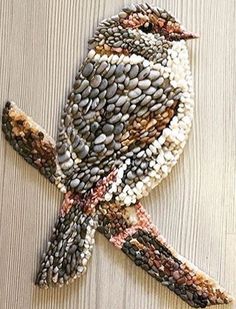 a bird made out of rocks and pebbles