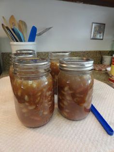 two jars filled with food sitting on top of a table