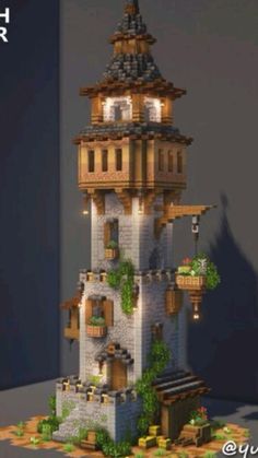 a tall tower with plants growing out of it's sides and lights on the top