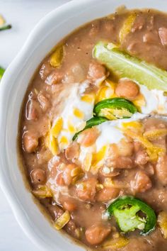 a white bowl filled with beans and vegetables