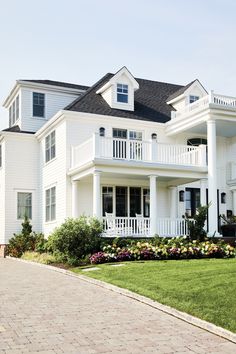 a large white house with lots of windows and balconies