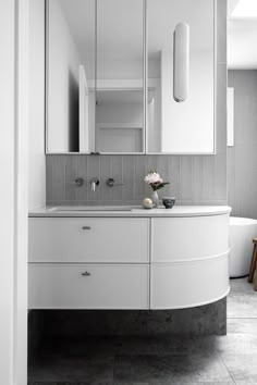 a bathroom with a sink, mirror and bathtub