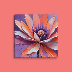 an orange and purple flower on a pink background