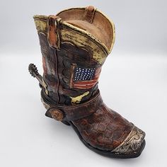 Add a touch of the Wild West to your home décor with this beautifully crafted hand-painted resin cowboy boot bank. Standing at 7 inches tall, this multicolor boot features a distressed finish and intricate details that make it a perfect addition to any collection. Whether you're a fan of cowboys or just love collecting unique decorative items, this boot bank is sure to impress. Made from high-quality resin, this bank is durable and long-lasting. It's perfect for all occasions and will add a touc Painted Resin, Western Lifestyle, The Wild West, Cowboy Boot, Wild West, Intricate Details, Boots Shoes, A Fan, Cowboy Boots