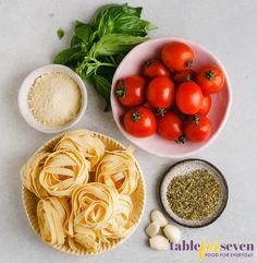 pasta, tomatoes, garlic and basil on a table