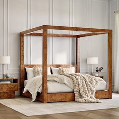 a bedroom with a four poster bed and white walls