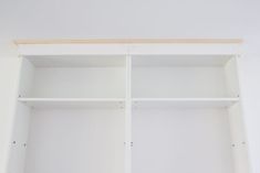 an empty white bookcase with no one in it