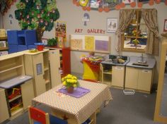 a child's playroom is shown with toys on the table and other furniture