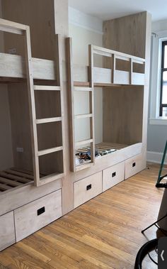 a room with bunk beds and drawers in it