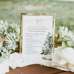 a table with a sign and flowers on it