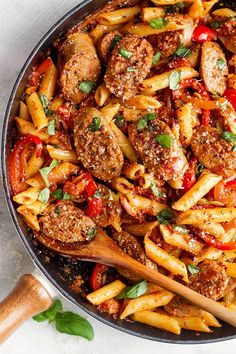 a skillet filled with pasta and meat