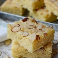 two pieces of cake with almonds on top