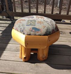 a wooden bench with a footstool on top of it in the middle of a deck