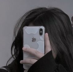 a woman holding her phone up to her face