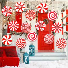 red and white candy canes hanging from the ceiling in front of a christmas door