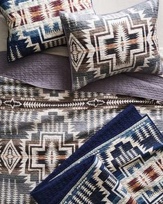 the comforter and pillows are all made up in southwestern style patterns, with blue accents