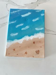 an acrylic painting of the beach with hearts and stars on it's side