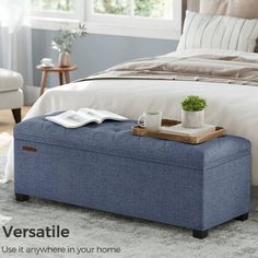 a bed with a blue ottoman sitting on top of it