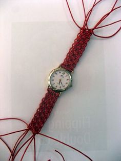 a watch is wrapped in red string