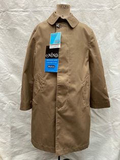 French vintage, beige school Mac, rain coat. Dead-stock with tags  Made in France.  Excellent quality. 67% cotton, 33% polyester  Fly-front button closure to front, 2 front pockets, centre vent Mint un-worn condition, no damage. Beautiful finish to fabric Shoulder 13.5 inches Chest 32 inches Sleeve 17.5 inches Length 27.5 inches Measurements are taken with the item flat. Please compare sizing with a garment you already own to be exact. Thank you for looking, convo me with any questions. ------------------------------- We specialise in NOS and pre-owned French workwear and have many items in stock so if you want something particular please ask.  Wholesale and bundle enquiries welcomed. I combine shipping and always provide refunds and deals on multiple purchase Buy with full confidence. We Classic Solid Raincoat With Pockets, Classic Solid Raincoat With Button Closure, School Coat, Mac Coat, French Workwear, Men Style Tips, Rain Coat, French Vintage, Made In France