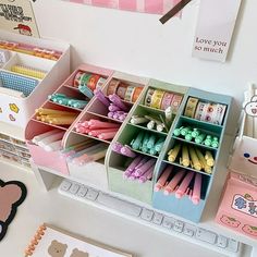 an assortment of stationery items are displayed on a desk with hello kitty magnets