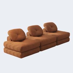 a brown couch sitting on top of a white floor