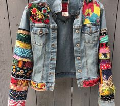 a jean jacket with colorful patches on it