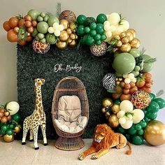 a baby shower with giraffes, balloons and other decorations on the wall