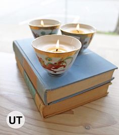 three tea lights sitting on top of a book